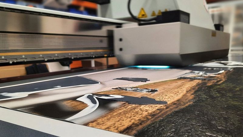 A close up of a printer in action, as it prints the multiple fine layers required to create subtle tactile changes.