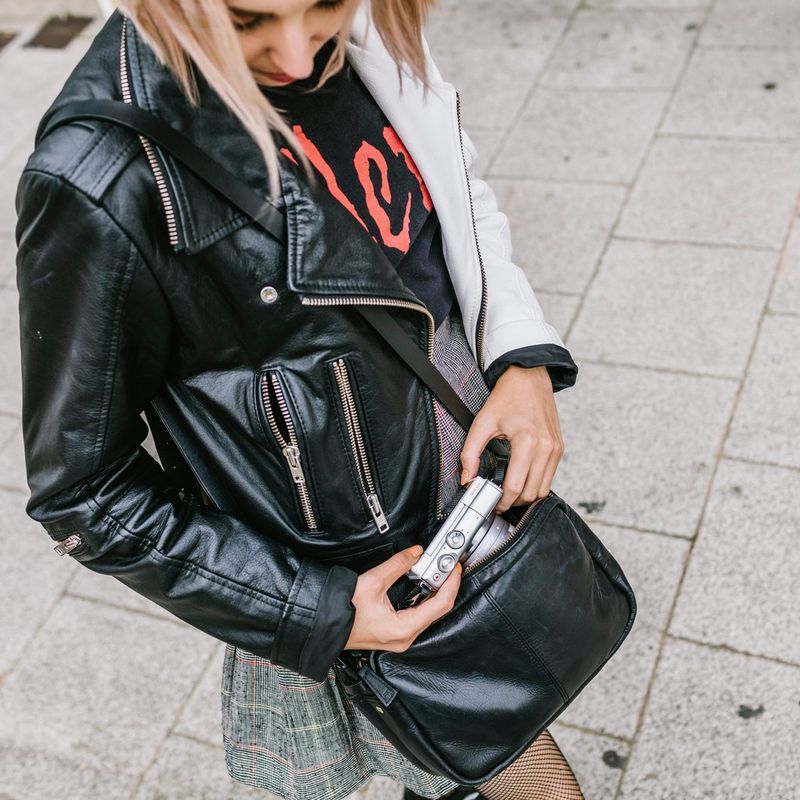 Canon EOS M100 Grau + EF-M 15-45mm f/3.5-6.3 IS STM Objektiv Silber 0 Eine Frau, die die Kamera auf einer Straße verwendet