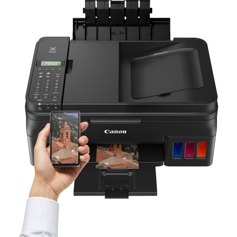 Canon PIXMA G4511 drahtloser All-in-One MegaTank Farbdrucker mit nachfüllbaren Tintenbehältern + zusätzliche schwarze Tinte Produkt Ansicht von oben mit einer Person, die von einem Smartphone aus druckt