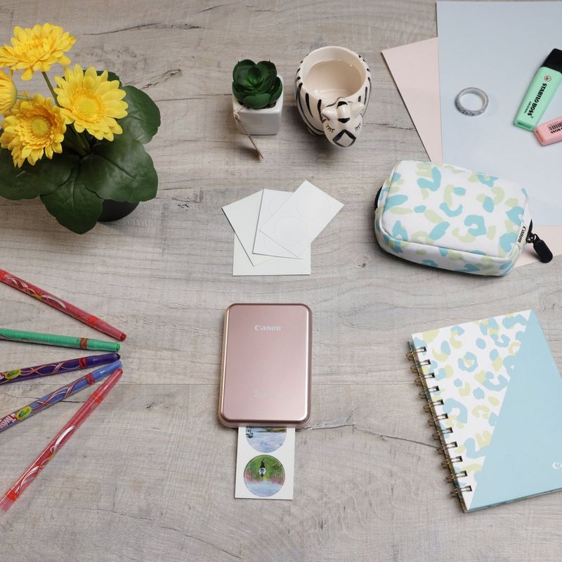 Canon Zoemini Mini-Fotodrucker, Roségold + Tagebuch + Tasche Drucker auf einem Schreibtisch mit Stiften