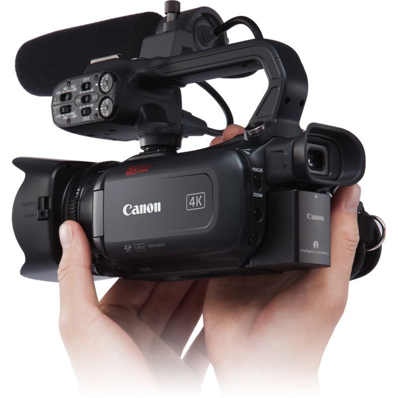 Canon XA40 Camcorder Rückansicht von links mit Mikrofon oben und Händen, die den Camcorder tragen