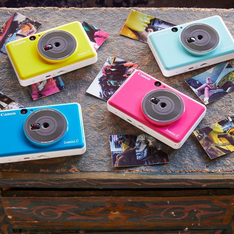 Canon Zoemini C Sofortbildkamera und Mini-Fotodrucker, Bumblebee Gelb 4 Drucker auf einem Schreibtisch mit Fotos