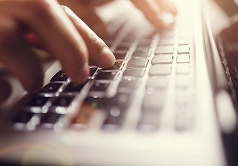 Person typing on keyboard