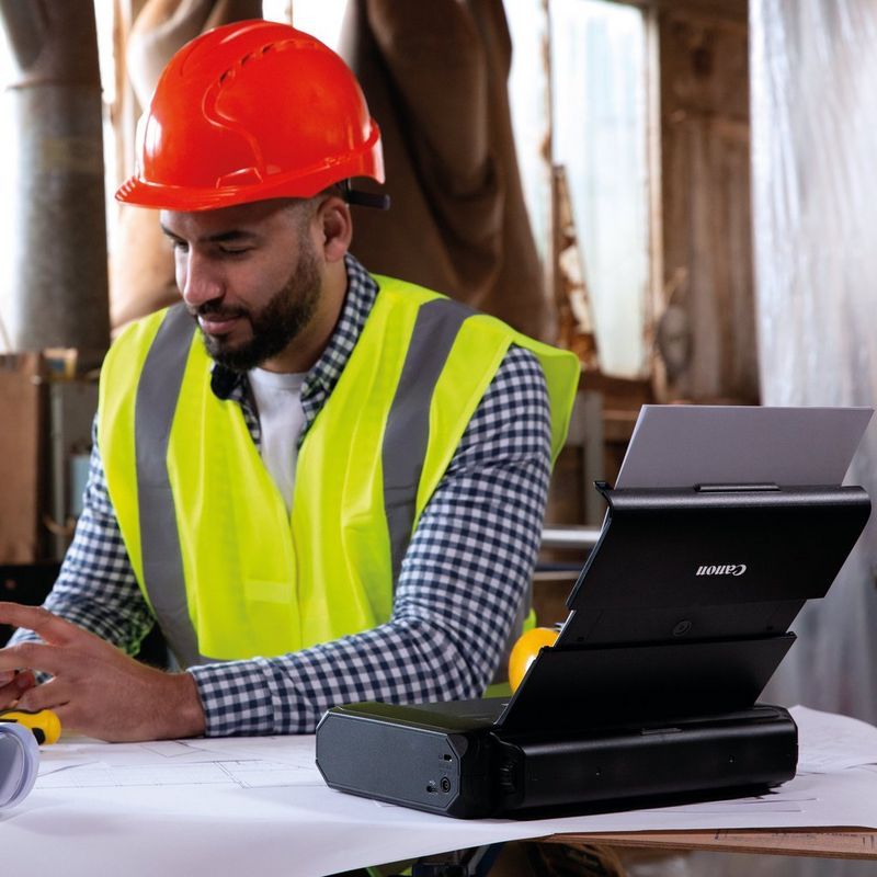 Canon LK-72 Battery Pack 0 man in red hat sitting besides the battery