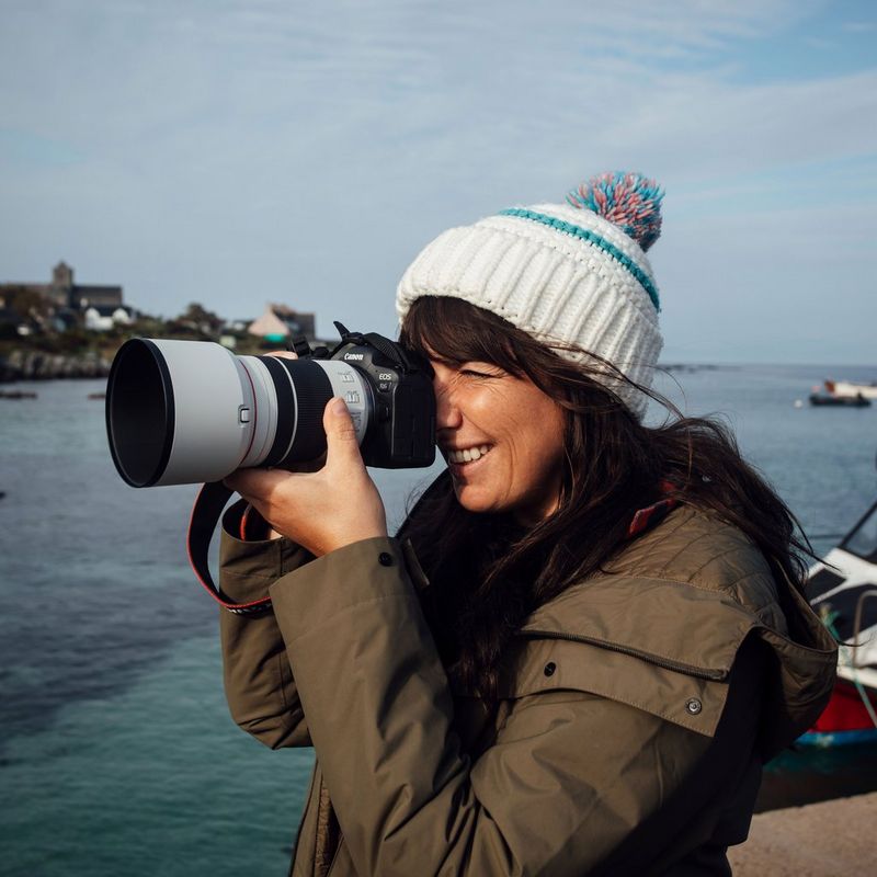 Canon RF 70-200mm F4L IS USM Objektiv Eine Frau, die eine Kamera vor ihr Gesicht hält