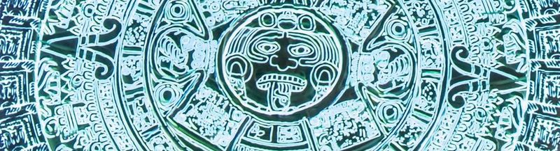Close-up detail of the projected Aztec Sunstone, showing glyphs in circles around the face of the fifth god.