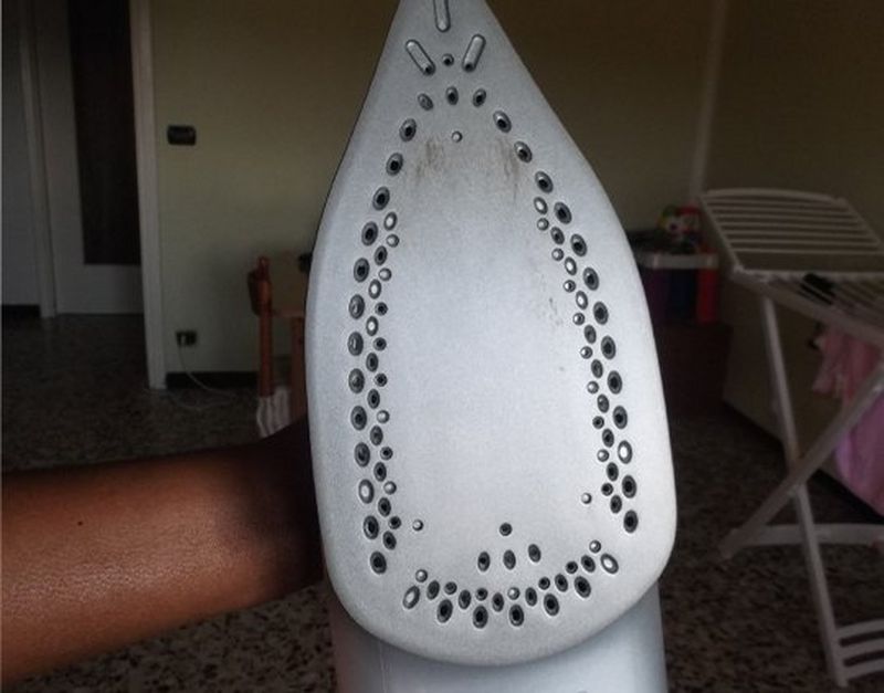 A hand holding an iron