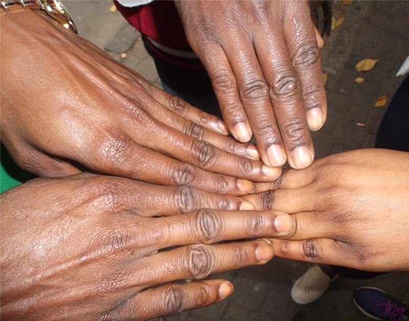 Four hands touching.