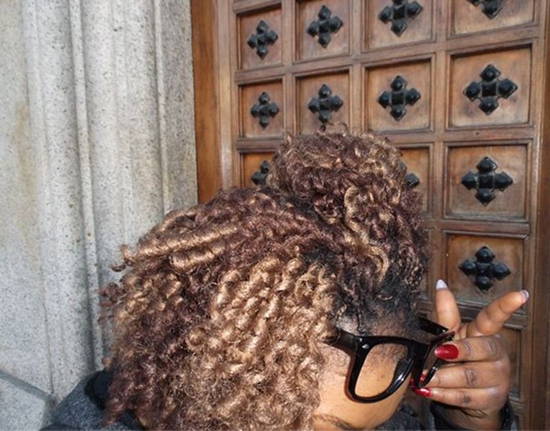 The top of a woman’s head, with spectacles on.