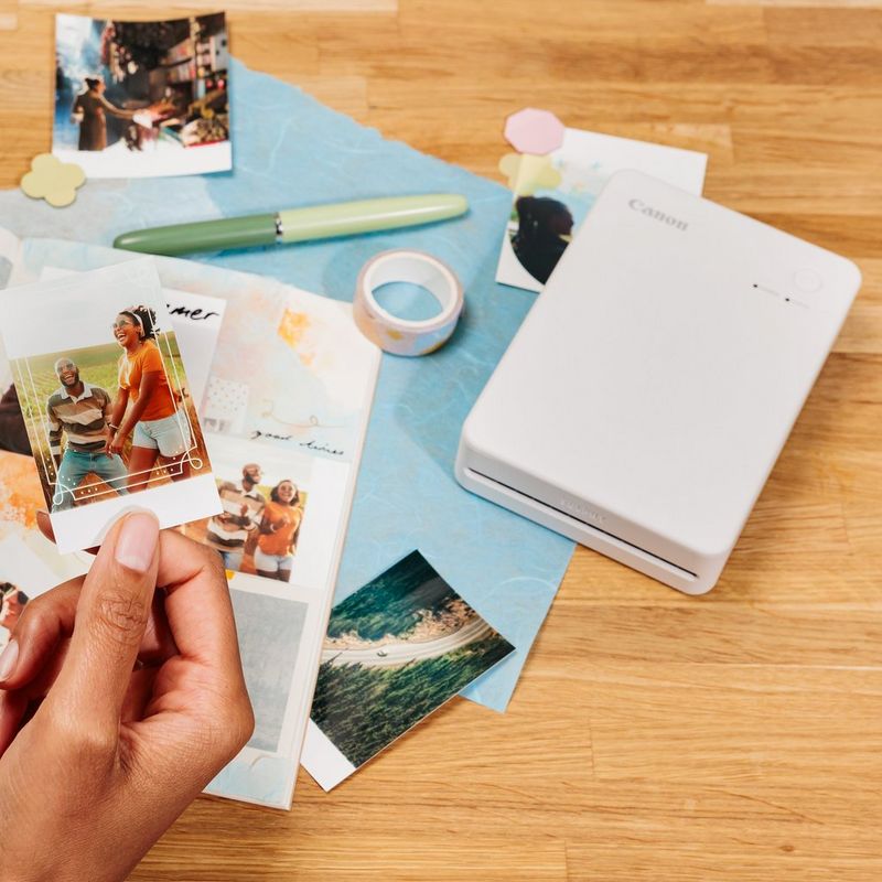 Canon SELPHY QX20 mobiler WLAN-Farbfotodrucker, Sandweiß Produkt mit gedruckten Fotos