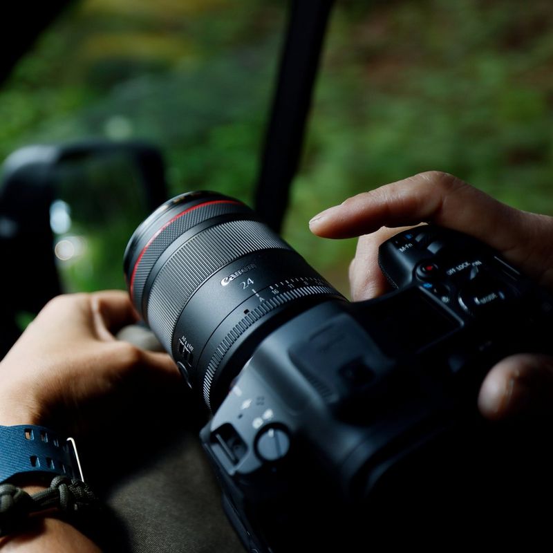 Canon RF 24mm F1.4L VCM Objektiv Mann, der ein Foto von einem Auto aus knipst