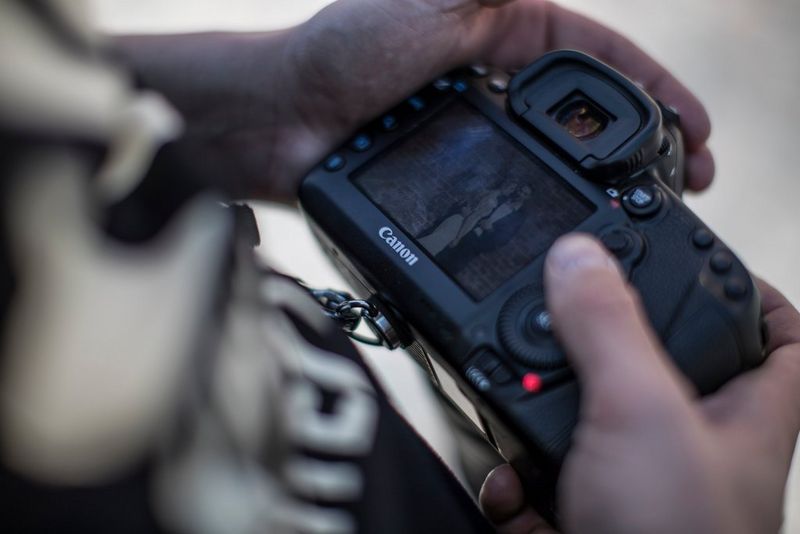 Photographer looking at pictures on a Canon camera display