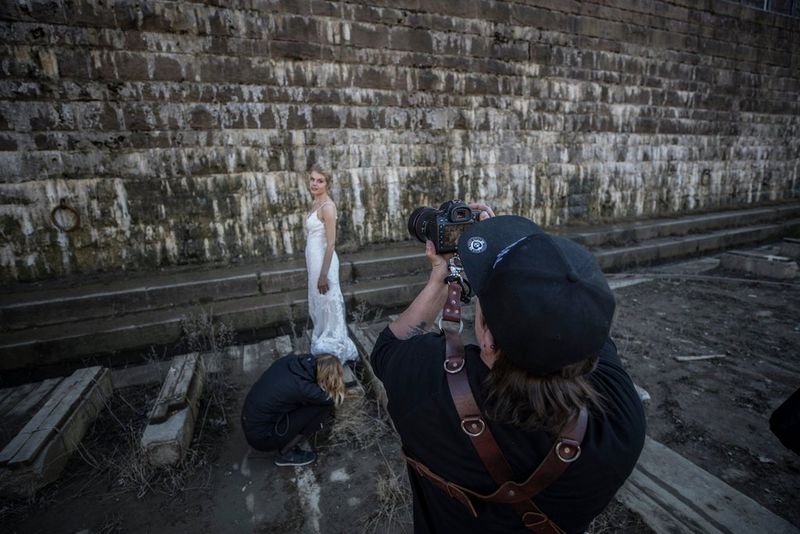 Photographer taking a picture of the bride with a Canon camera