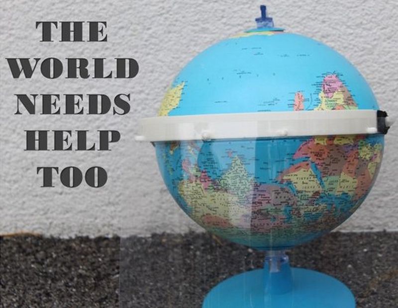 A photo of a globe ‘wearing’ a plastic PPE visor, accompanied by the caption ‘the world needs help too’