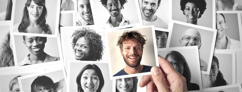 Black and white image of faces with one image in colour