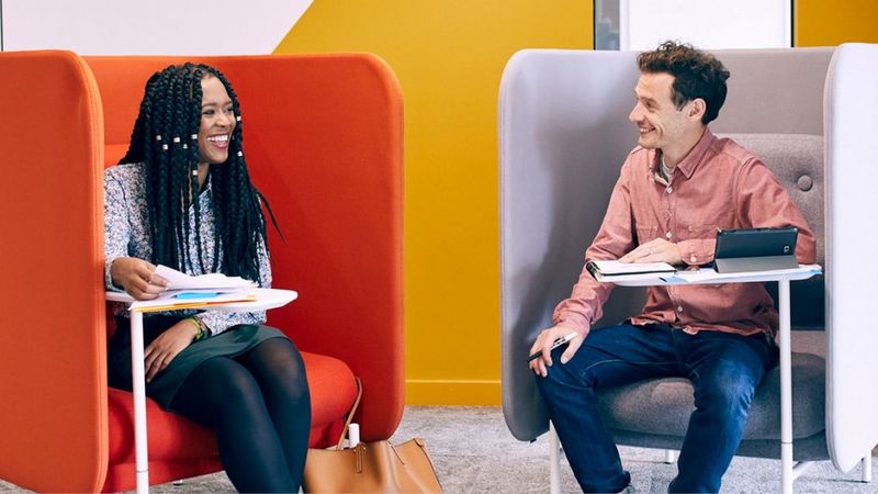 Two co-workers in their office