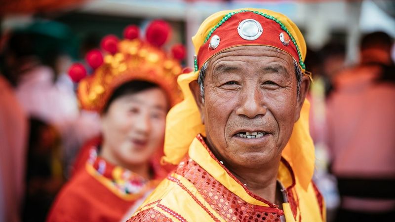 Close portrait of old, smiling man by Martin Bissig