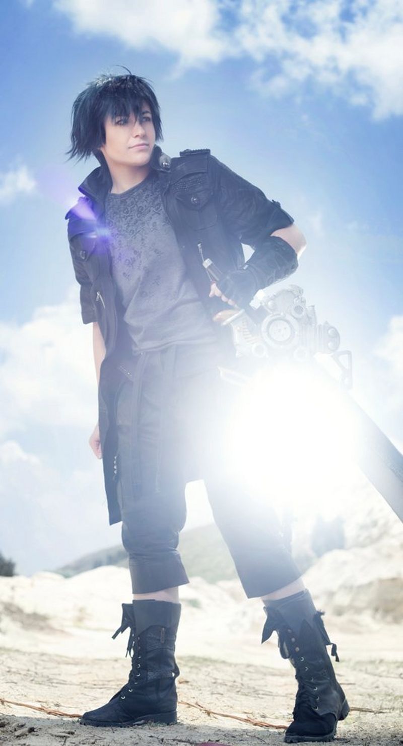 A man in a cosplay costume appears to stand in the desert, with a blue sky and bright sunshine behind him.