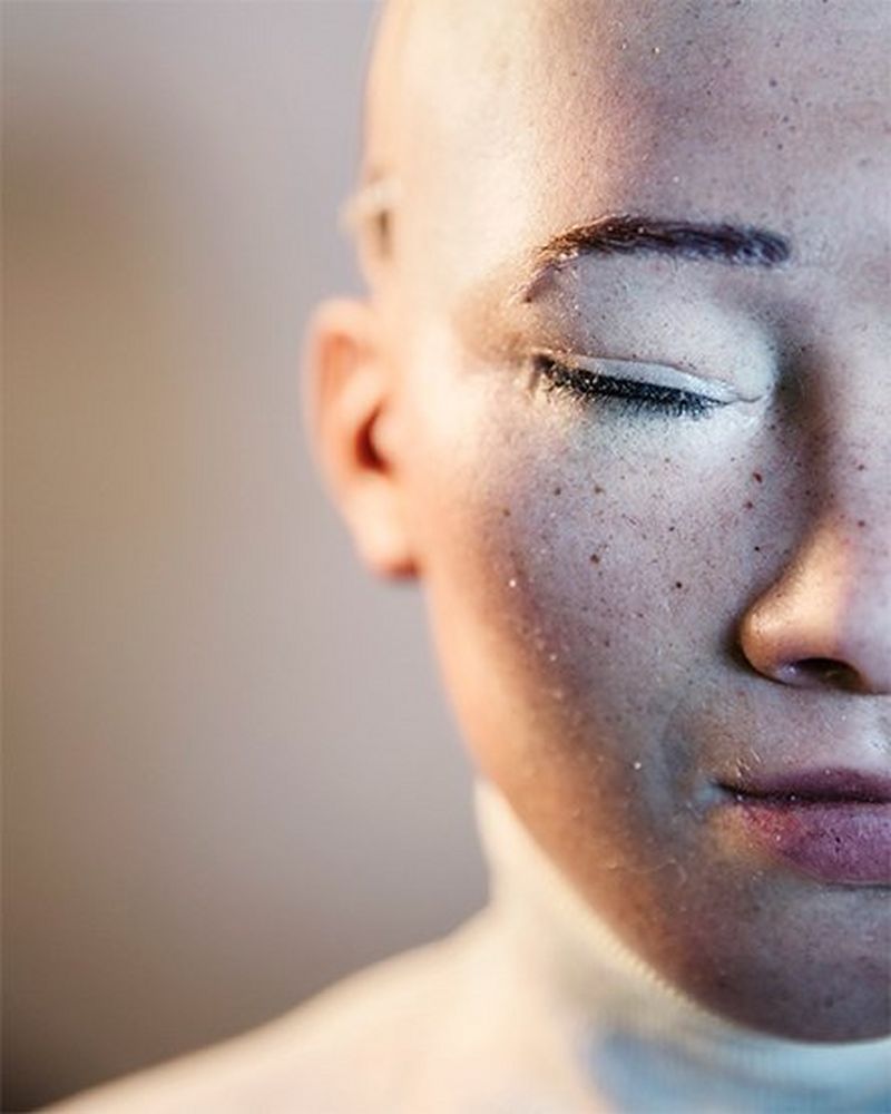 An ultra close-up shot of Sophia, cropped to show only the right side of her face, with her lifelike freckles and eyebrows clearly visible.