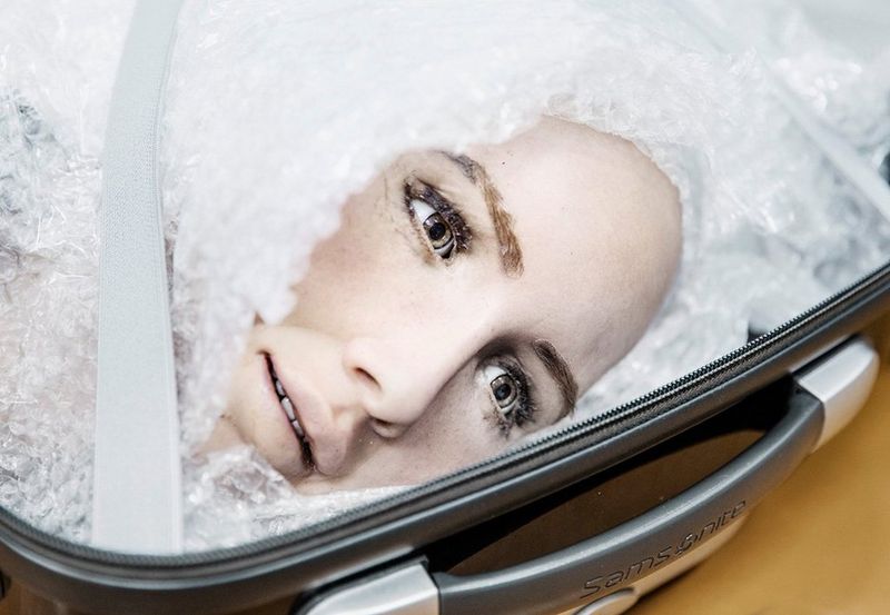 A close-up of Sophia's head, in a suitcase and protected in bubble wrap, ready to be transported.