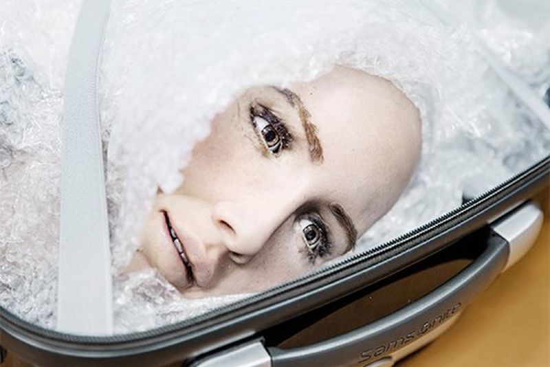 A close-up of Sophia's head, in a suitcase and protected in bubble wrap, ready to be transported.