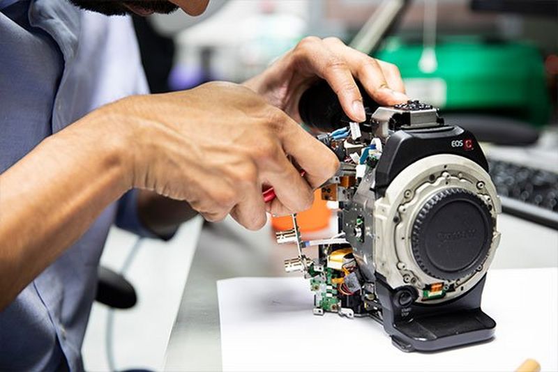 A specialist working on a Canon EOS C body