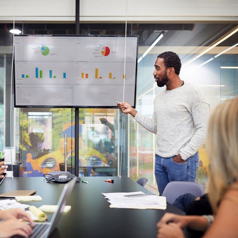 Man presents financial information to meeting