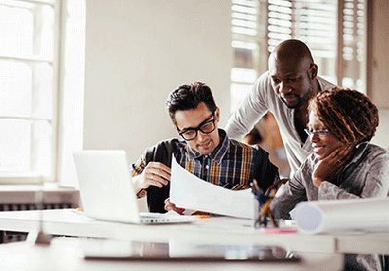 Three people collaborating together