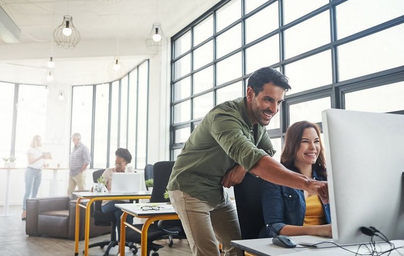 Male and female next to a computer
