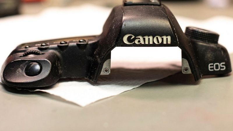 Canon EOS camera body top awaiting repair