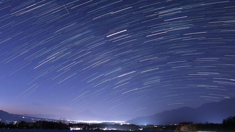 star trails over body of water