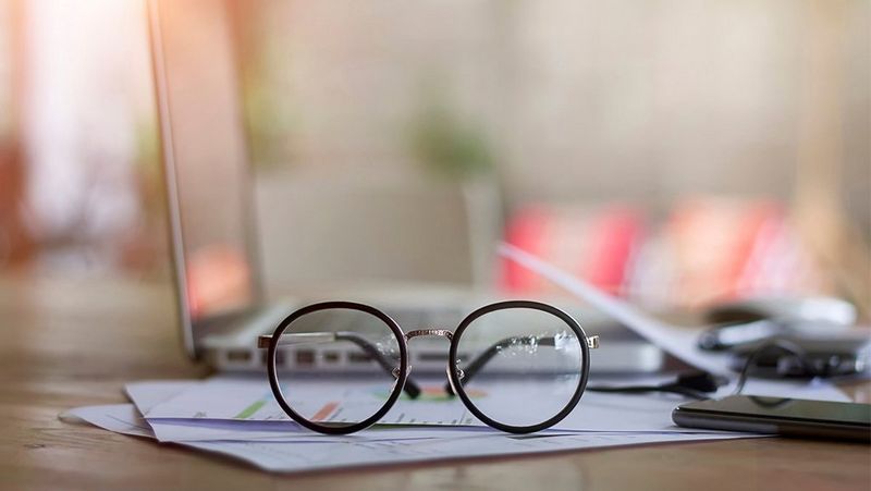 Glasses resting on documents on desk