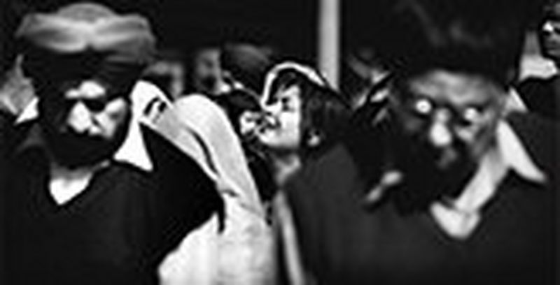 Woman crying in a crowd of people