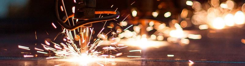 Sparks flying, as an industrial drill hits metal.