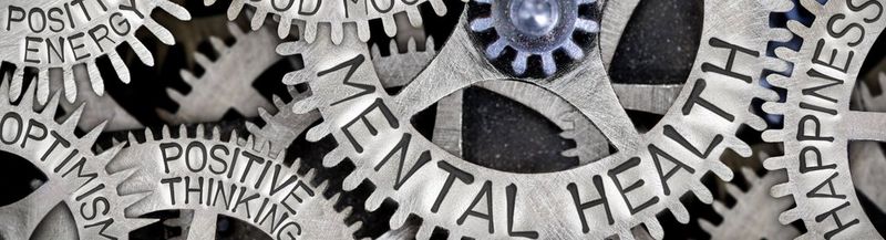 Interconnected cogs, engraved with the words, ‘mental health’, ‘happiness’, ‘positive thinking’, ‘positive energy’ and ‘optimism.’