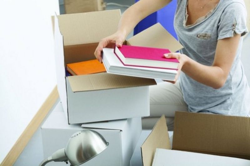 Girl unpacking books from box