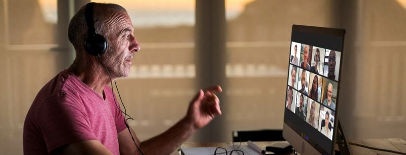 Canon UK - Man with headphones in front of laptop