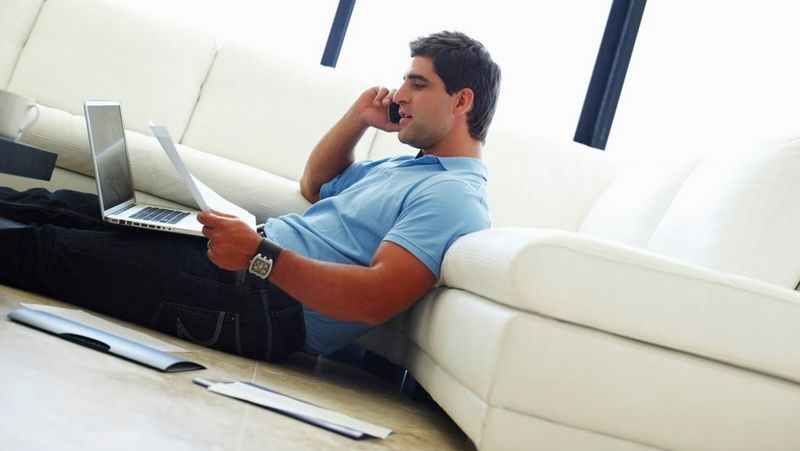 Man sat on floor with laptop 