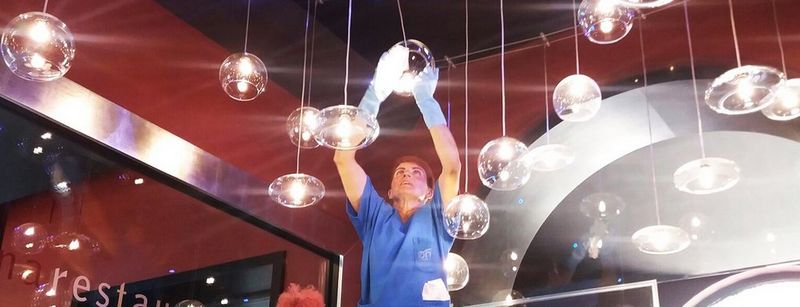 Middle-aged man in shirt walks between warehouse shelving