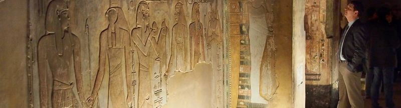 A man looks at a replica Egyptian tomb