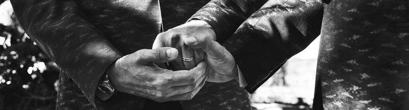 Close up of newly-weds holding hands	 