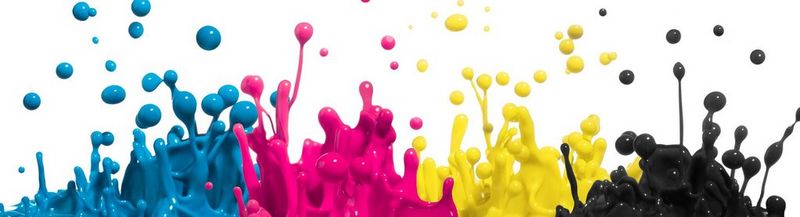 Four different colours of ink – cyan, magenta, yellow and black – splashing into the air.