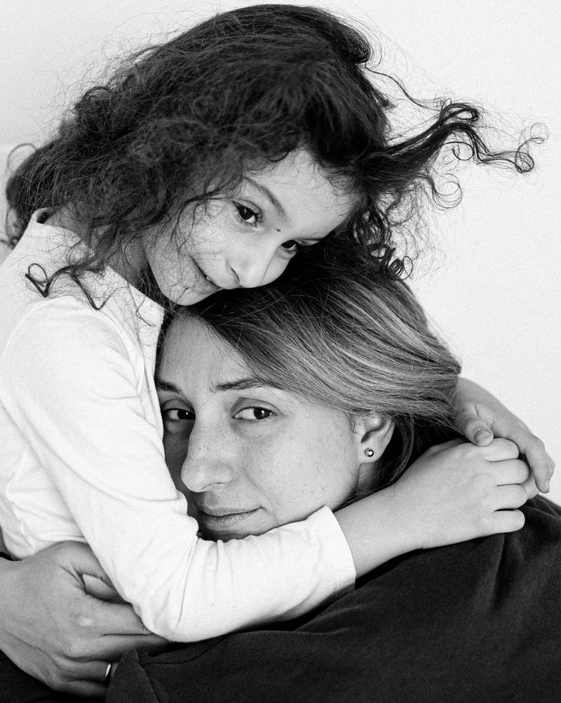 A black-and-white shot of Marina Karpiy holding her daughter.