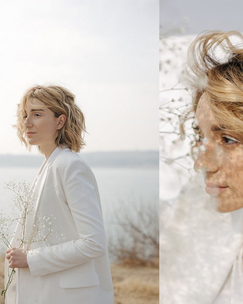 A self-portrait of Marina Karpiy wearing a white jacket. 