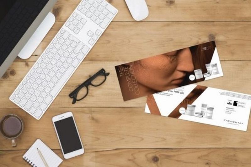 Campaign direct mail on table with computer, glasses and phone