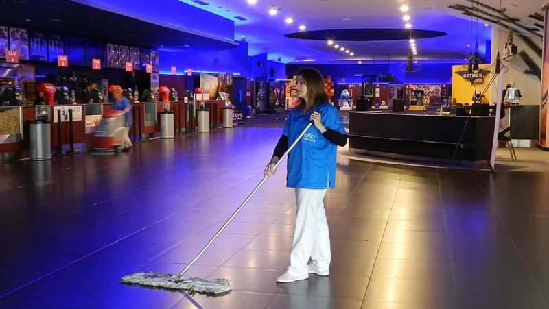 Man in high visibility vest takes stock of boxes in electrical wholesaler warehouse