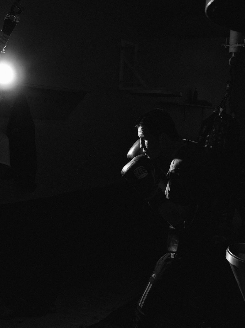 A boxer sparring with a punching bag.