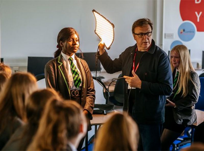 Two sculptures of unicorn heads, one in white and the other painted so black that it’s impossible to see the detail.