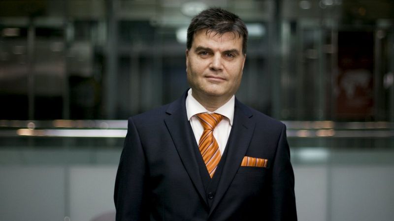 A Man wearing a suit poses for the camera