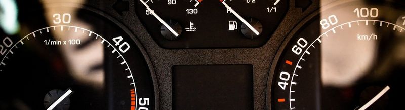 A close up of the tops of the left and right speedometers in a car. The fuel gauge is partially cut off.